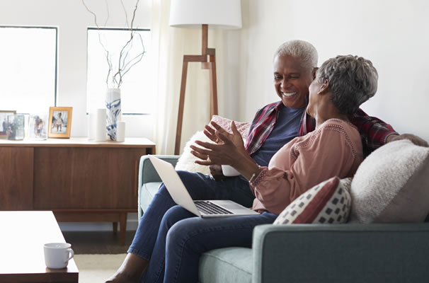 elderly couple using laptop