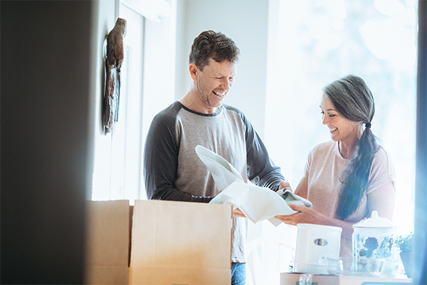 Couple unpacking moving boxes