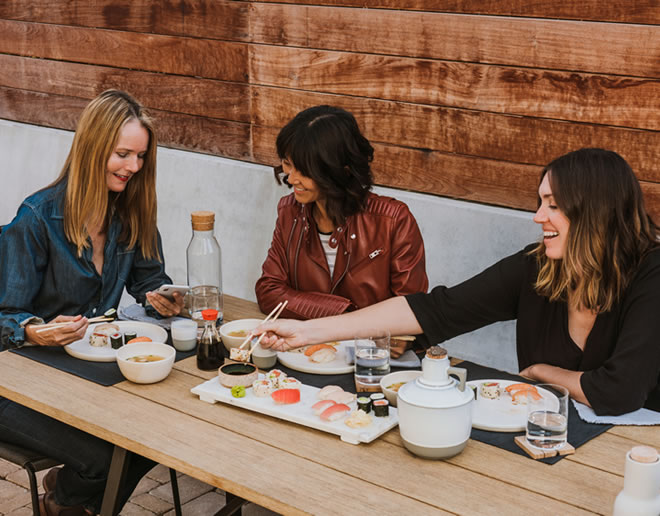 women eating sushi